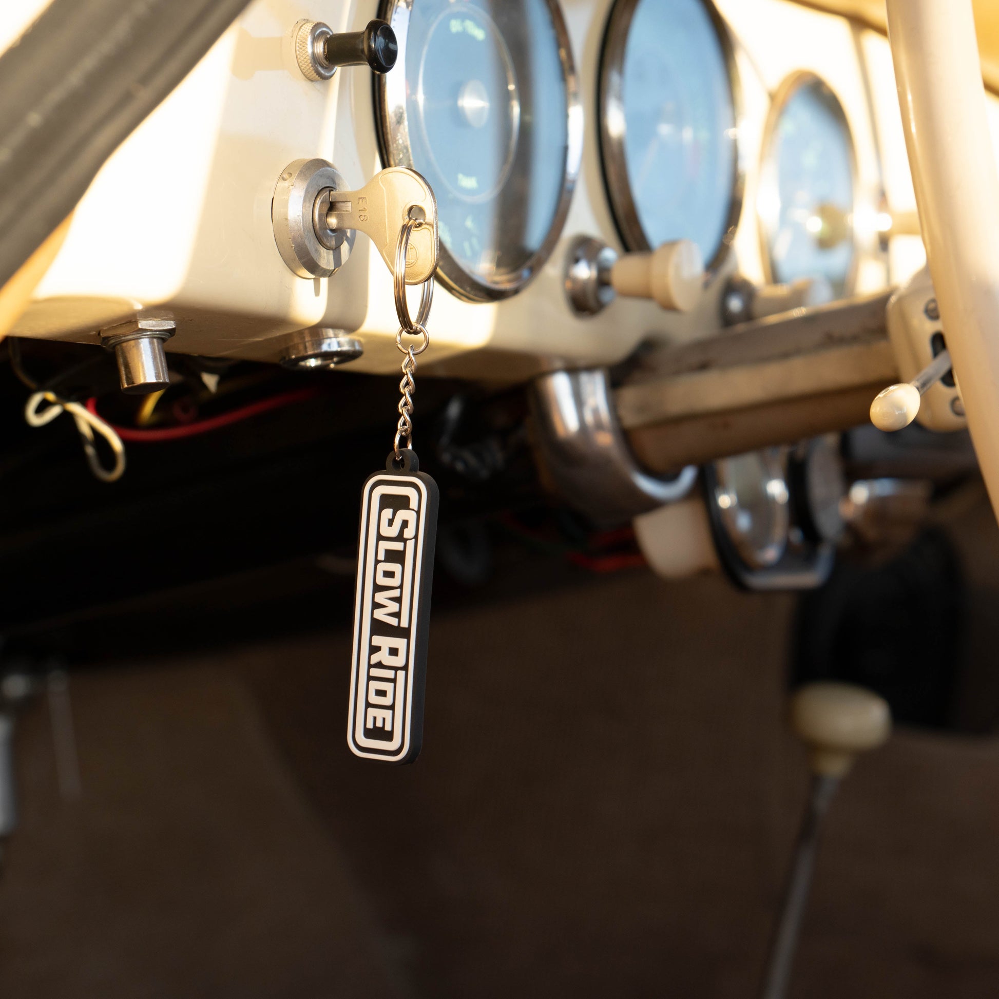 Radio Keychain - Slow Ride- Classic Slow Ride keychain featuring the iconic 'Slow Ride' logo in black and white, perfect for fans of Off-Roading and Off-Road Racing. This keychain is an ideal accessory for vintage Volkswagen enthusiasts, including those who love the Volkswagen bus, Volkswagen bug, and Baja bug. A great addition to any Garage and Racing lifestyle, this keychain embodies the spirit of Slow Ride Garage and mottos like 'Enjoy Getting There,' 'Wheelin and Spilling,' and 'Restore and Destroy.' A