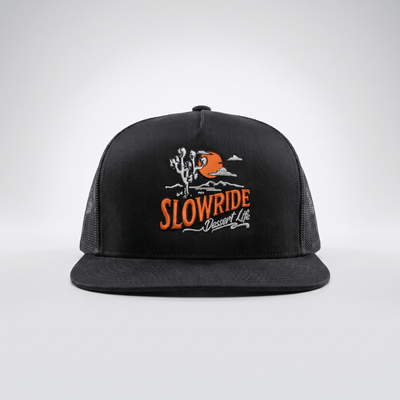 Landscape Trucker front view, Black trucker cap with embroidered desert scene, orange moon, Joshua tree, and white text